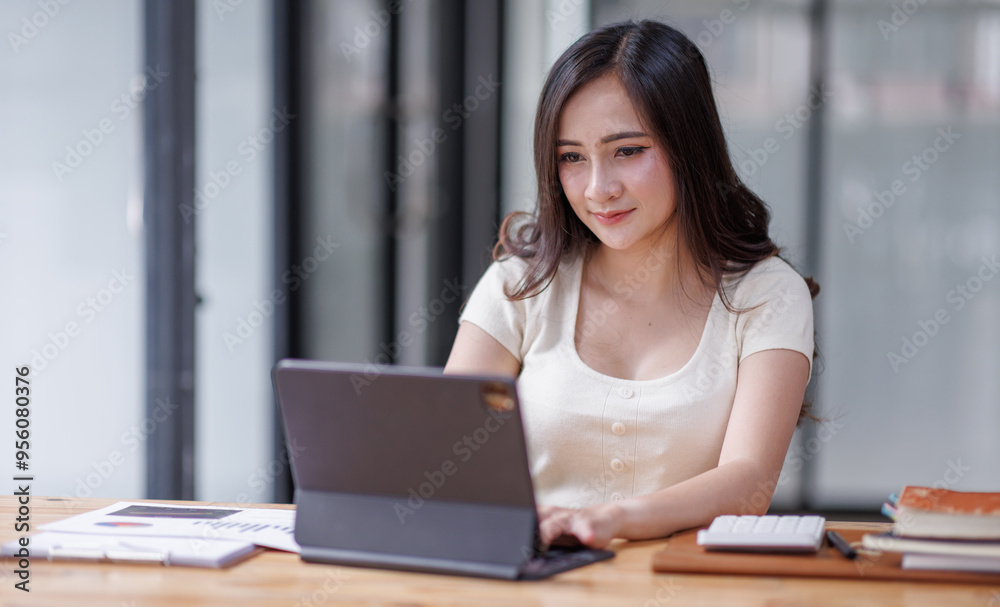 Businesswomen or Asian Accountants using calculator and a tablet laptop computer to analyze business report graphs and finance charts at the workplace, financial and investment concept.
Businesswomen or Asian Accountants using calculator and a tablet laptop computer to analyze business report graphs and finance charts at the workplace, financial and investment concept.