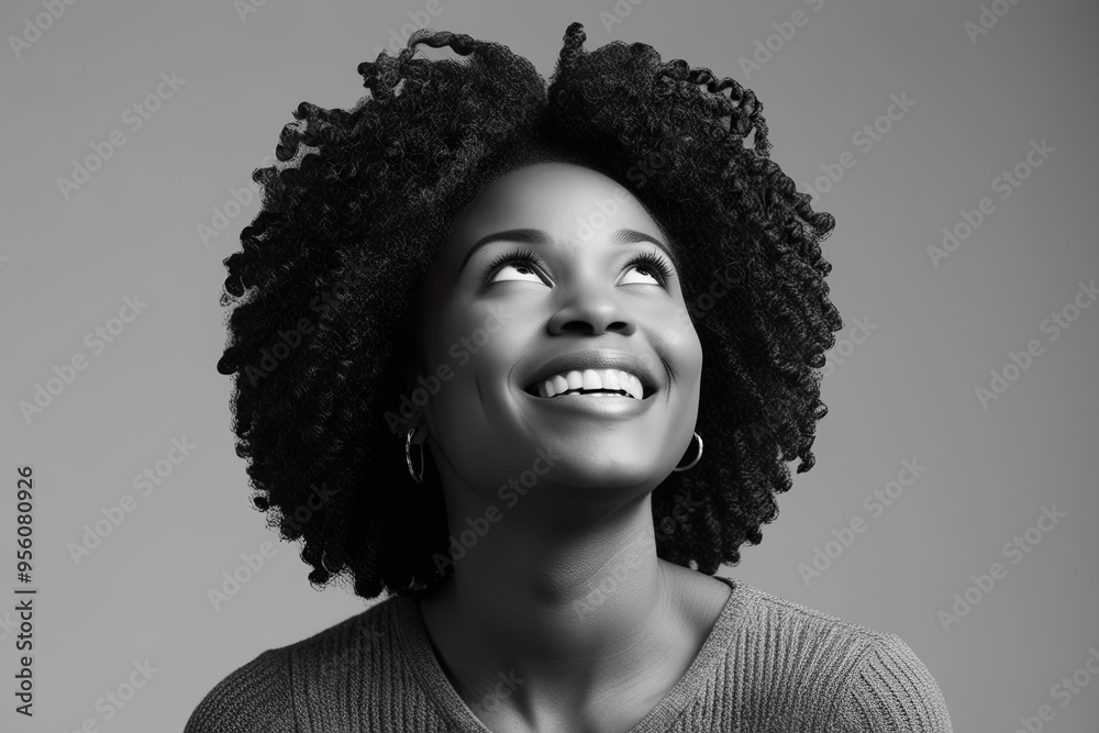 Joyful African American Woman with Curly Hair Looking Upward in Portrait Joyful African American Woman with Curly Hair Looking Upward in Portrait