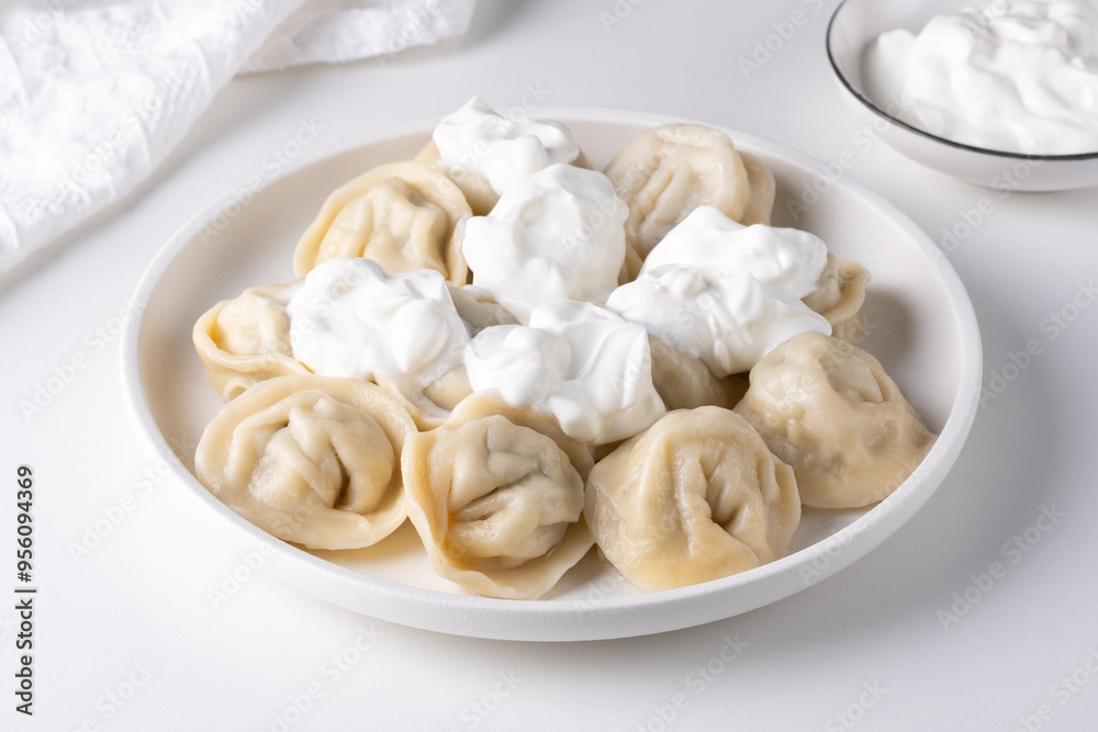 Traditional pelmeni, ravioli, dumplings filled with meat on plate, russian kitchen Traditional pelmeni, ravioli, dumplings filled with meat on plate, russian kitchen