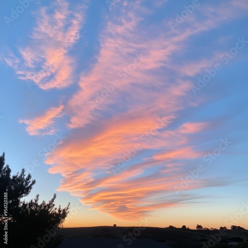 A beautiful sunset with pink and orange clouds against a blue sky.