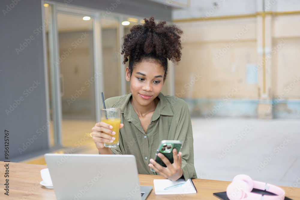 About successful young woman concept. Excited African American woman sitting at working desk. About successful young woman concept. Excited African American woman sitting at working desk.