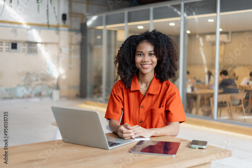 Free Download About successful young woman concept. Excited African American woman sitting at working desk. - GFXLoad