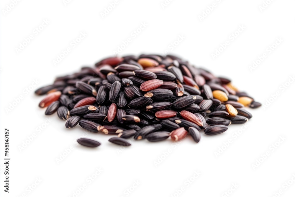 A handful of grains of black rice on a white background islated close up A handful of grains of black rice on a white background islated close up