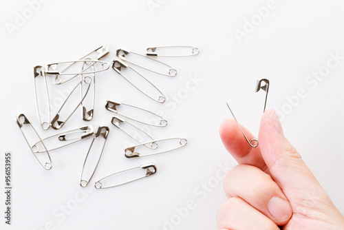 Safety pins on white background.