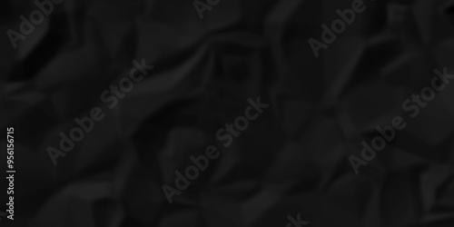 crumpled texture of dark black wrinkle chaotic paper. old crumple black paper sheet abstract shape background space for text.	
