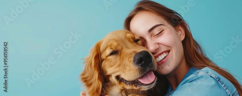 Woman hugging a friendly golden retriever, both smiling photo