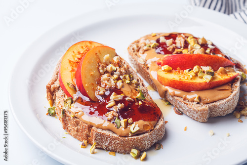 Peanut butter and jam jam with peach and nuts, white background.