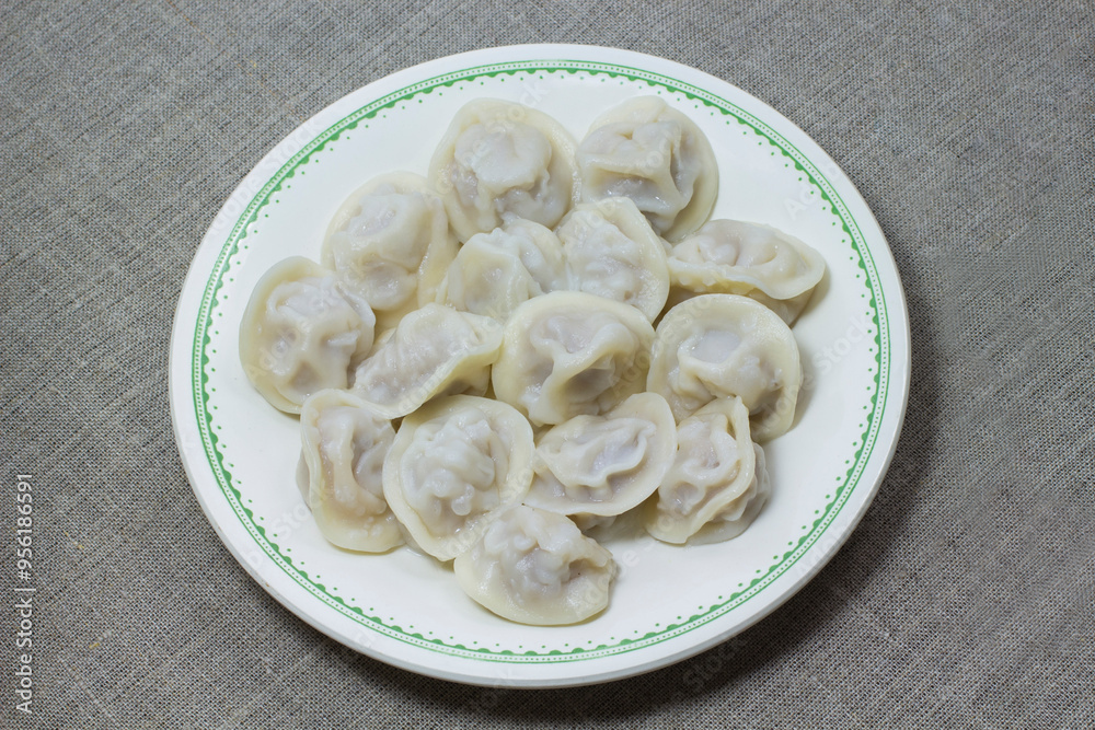 Plate with dumplings and fork on the table Plate with dumplings and fork on the table