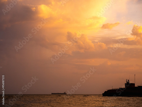 a ship is sailing in the ocean under a cloudy sky