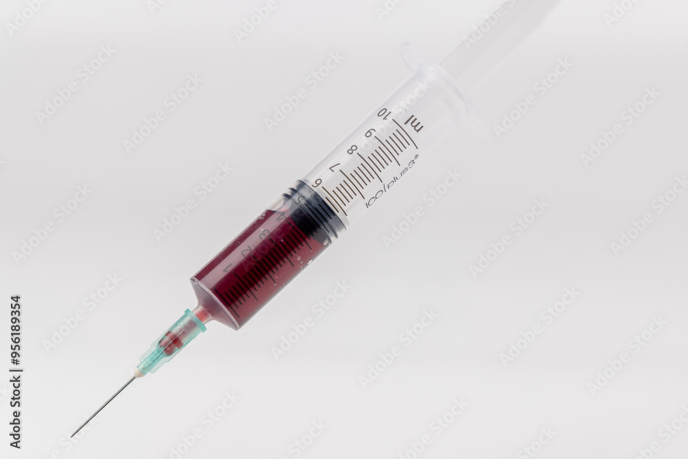 Blood-Filled Syringe Centered on White Backdrop Blood-Filled Syringe Centered on White Backdrop