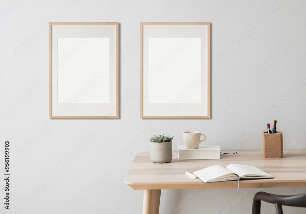 Blank picture frame mockup on white wall. Modern living room design. View of modern scandinavian style interior, minimalism concept. Two vertical templates for artwork, painting, photo or poster Blank picture frame mockup on white wall. Modern living room design. View of modern scandinavian style interior, minimalism concept. Two vertical templates for artwork, painting, photo or poster