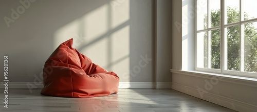 A red bean bag chair positioned by a window in a room with ample space for a copy space image