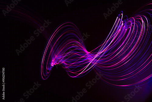 Swirling light trails against dark background