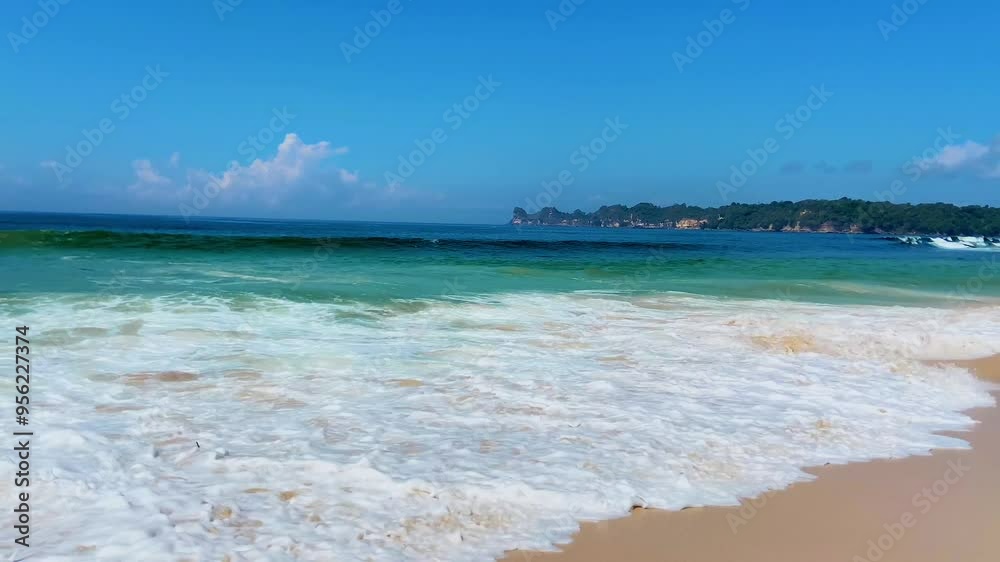 Aerial view of foamy waves crashing on the coastline Aerial view of foamy waves crashing on the coastline