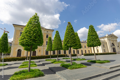 A large building with a row of trees in front of it