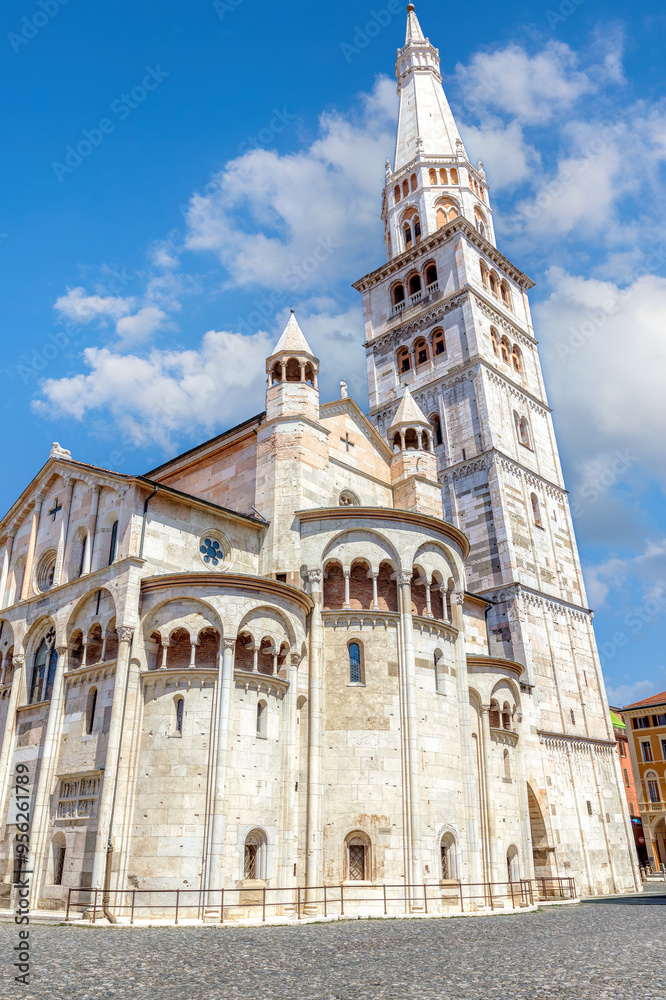Fototapeta premium The stunning Cathedral of Modena and Torre Civica tower under a vibrant blue sky in Piazza Grande, Modena, Emilia-Romagna. Italy