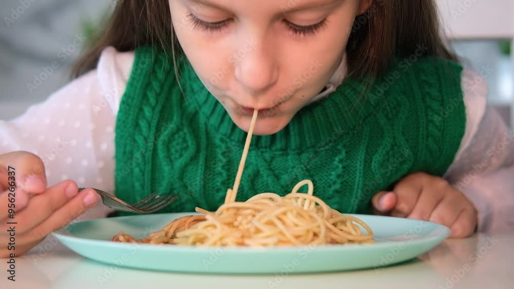 Portrait of girl having fun eating spaghetti. Child twists pasta on fork. Baby food concept. Portrait of girl having fun eating spaghetti. Child twists pasta on fork. Baby food concept.