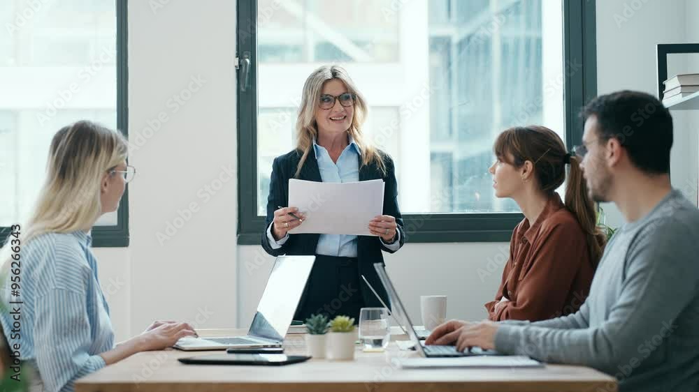 Senior businesswoman holding presentation at start-up business Senior businesswoman holding presentation at start-up business
