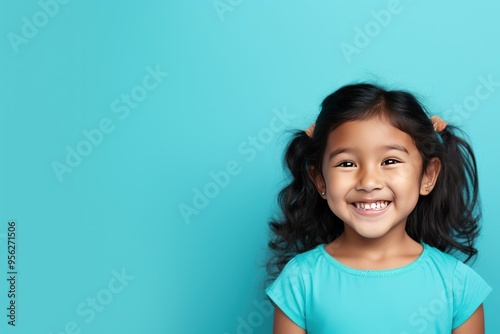 Cyan background Happy Asian child Portrait of young beautiful Smiling child good mood Isolated on backdrop ethnic diversity equality acceptance 