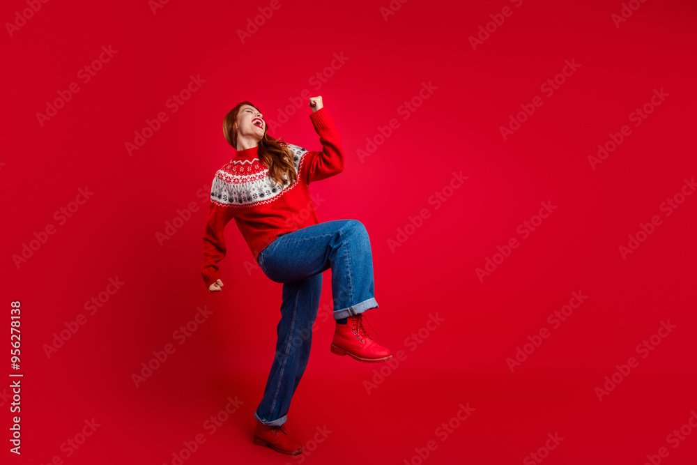Fototapeta premium Photo of young positive energetic lady dancing wearing seasonal sweater and jeans clubbing isolated on red color background
