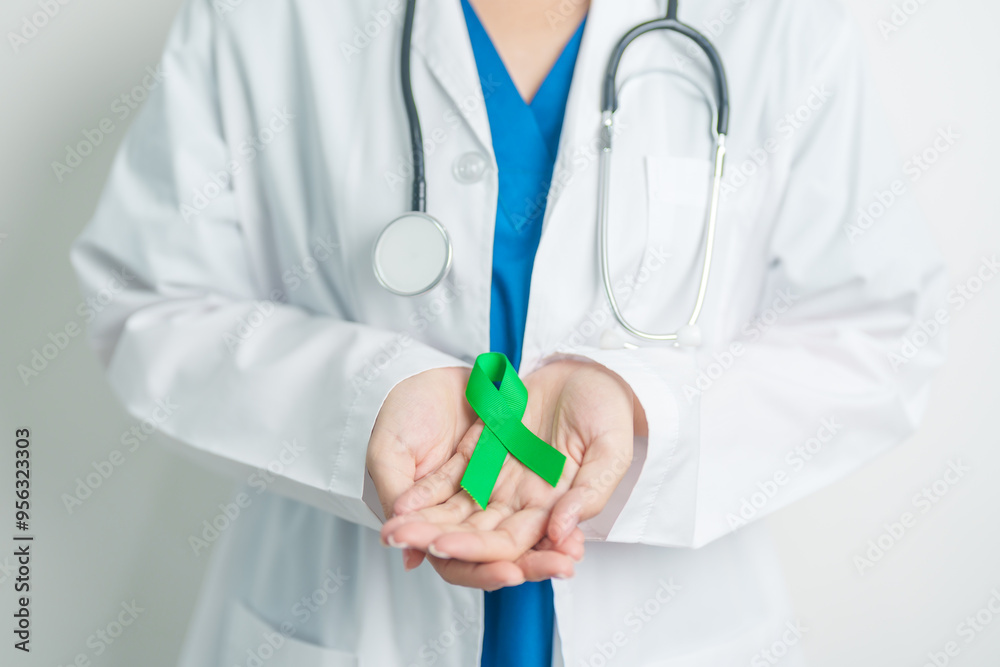 Doctor with green Ribbon for world Lymphoma Awareness September month, world Mental Health Day, Liver, Gallbladders, bile duct, cervical, kidney Cancer. Healthcare and world cancer day concept Doctor with green Ribbon for world Lymphoma Awareness September month, world Mental Health Day, Liver, Gallbladders, bile duct, cervical, kidney Cancer. Healthcare and world cancer day concept