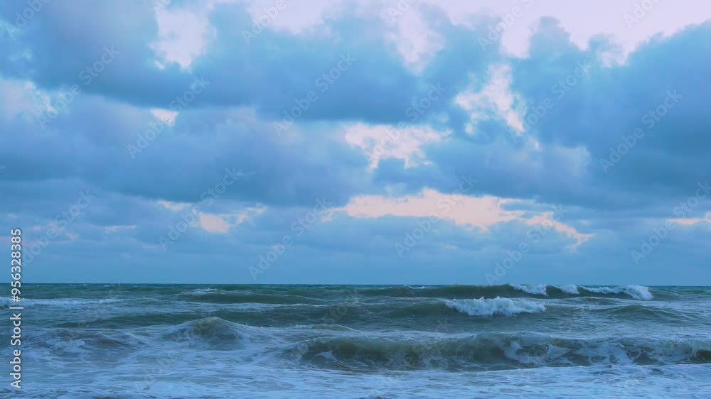 Ocean, Long Foaming Waves on Beautiful Cloudy Rainy Sunset, Lilac Yellow Sky with Colored Puffy Clouds Sea and Waves Falling on Shore Beach, Planet, Travel, Relax, Nobody. Ocean, Long Foaming Waves on Beautiful Cloudy Rainy Sunset, Lilac Yellow Sky with Colored Puffy Clouds Sea and Waves Falling on Shore Beach, Planet, Travel, Relax, Nobody.