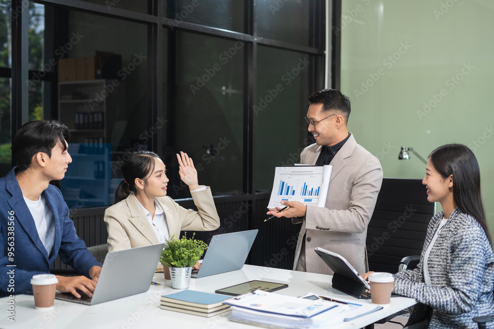 Naklejka premium Business, technology and office concept, businessman with laptop, tablet pc computer and papers having discussion in modern office.