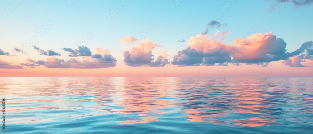 Fototapeta premium Peaceful sunset over calm ocean water with colorful clouds