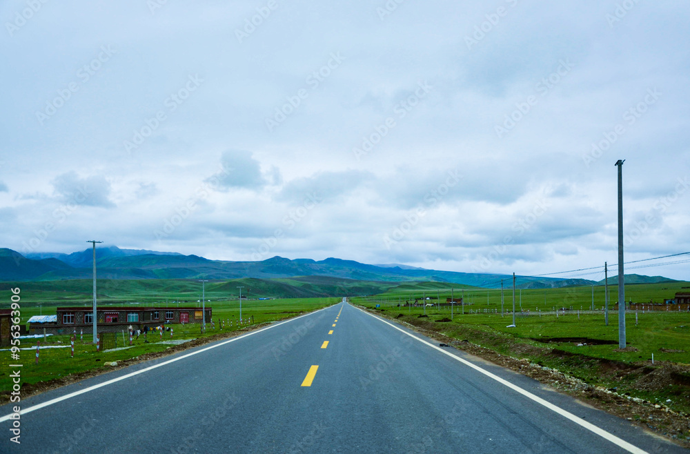 Highway view through green grasslands Highway view through green grasslands