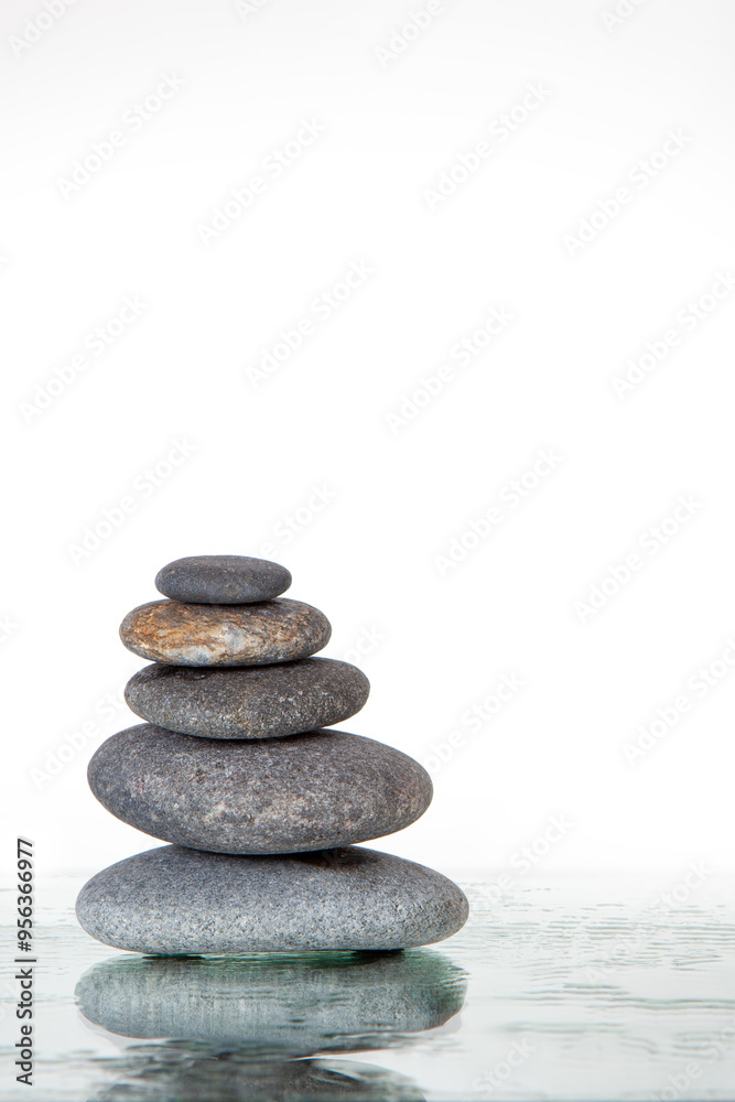 Stack of Smooth Gray Stones on Reflective Surface Stack of Smooth Gray Stones on Reflective Surface