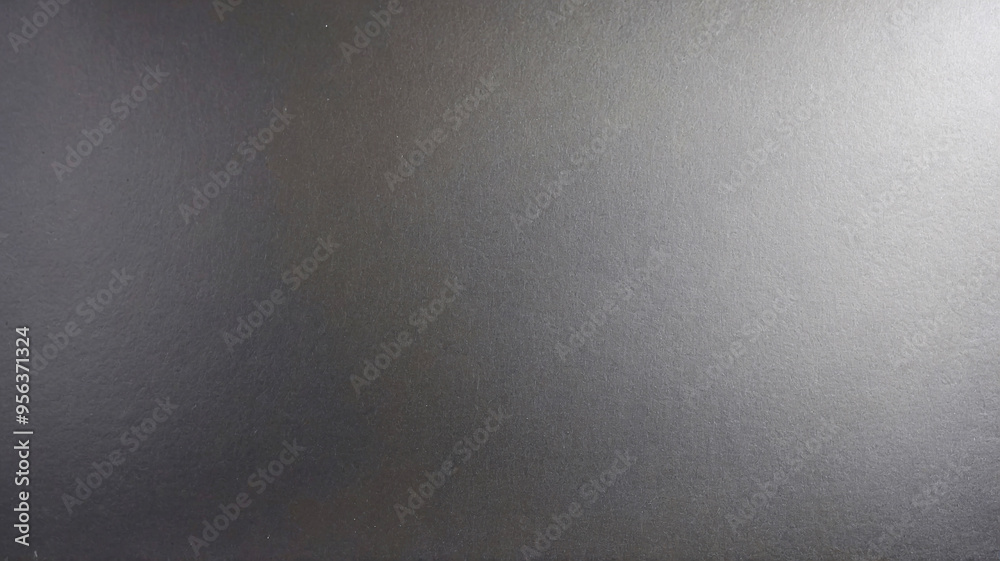 Macro shot of a smooth black chalkboard-like surface providing a consistent, plain, and sleek background image.