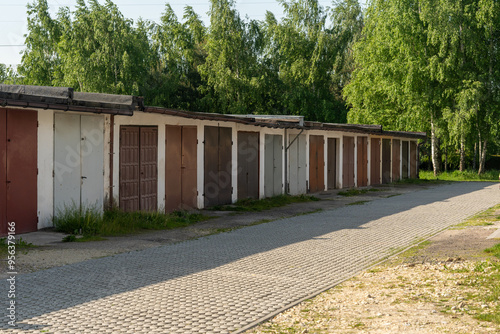 Schilderij op canvas Rows of old garages with colorful metal doors in Poland village