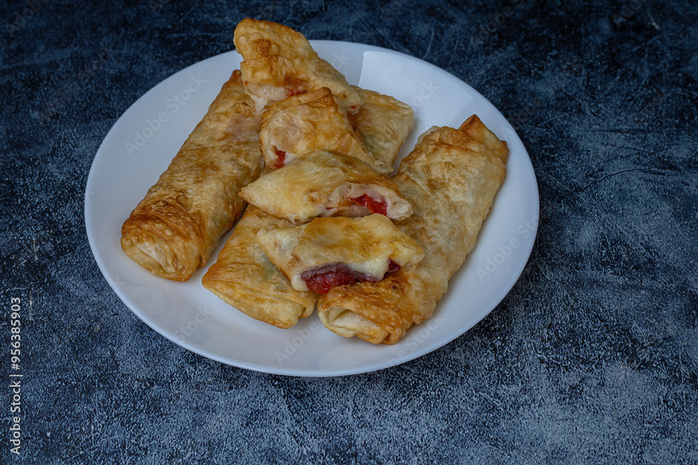 Turkish Pacanga Boregi with pastirma (pastrami) and cheddar (melted) cheese. - Pastirmali Borek