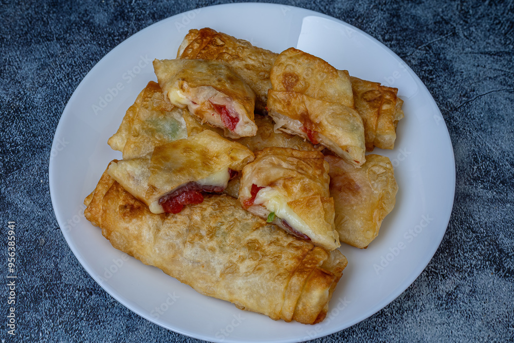 Turkish Pacanga Boregi with pastirma (pastrami) and cheddar (melted) cheese. - Pastirmali Borek
