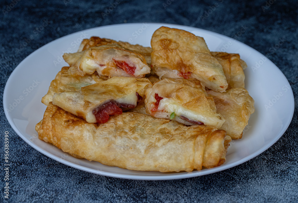 Turkish Pacanga Boregi with pastirma (pastrami) and cheddar (melted) cheese. - Pastirmali Borek