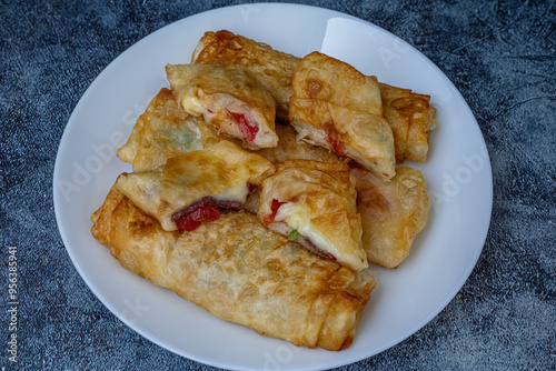 Obraz na płótnie Turkish Pacanga Boregi with pastirma (pastrami) and cheddar (melted) cheese. - Pastirmali Borek w salonie