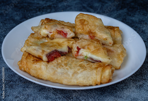 Obraz na płótnie Turkish Pacanga Boregi with pastirma (pastrami) and cheddar (melted) cheese. - Pastirmali Borek w salonie