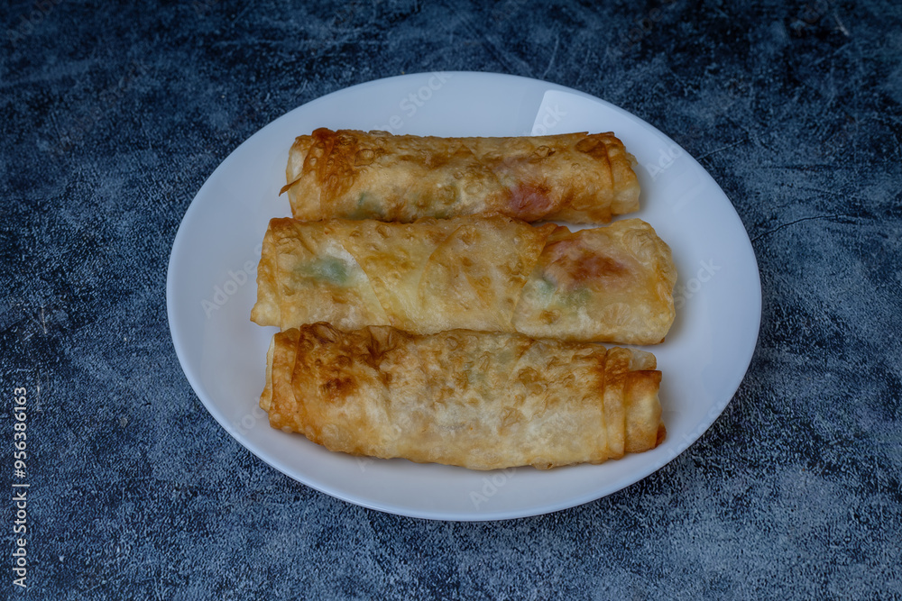 Turkish Pacanga Boregi with pastirma (pastrami) and cheddar (melted) cheese. - Pastirmali Borek