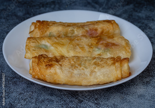 Turkish Pacanga Boregi with pastirma (pastrami) and cheddar (melted) cheese. - Pastirmali Borek photo