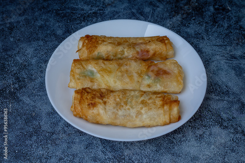 Obraz na płótnie Turkish Pacanga Boregi with pastirma (pastrami) and cheddar (melted) cheese. - Pastirmali Borek w salonie
