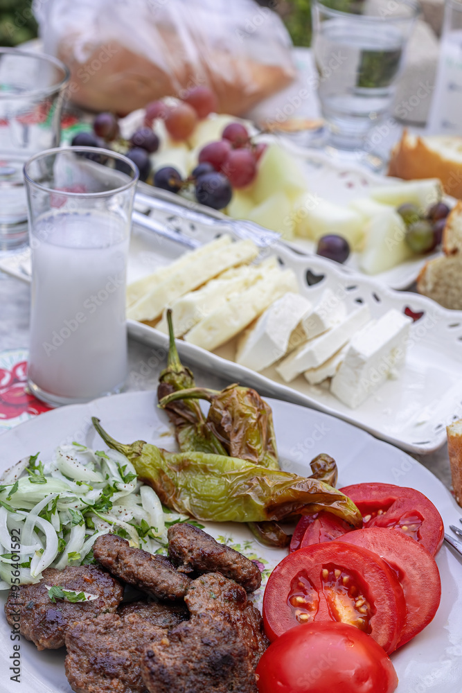 The famous Milas meatballs made by kneading tomatoes, onions, roasted peppers, lamb and beef on a plate
