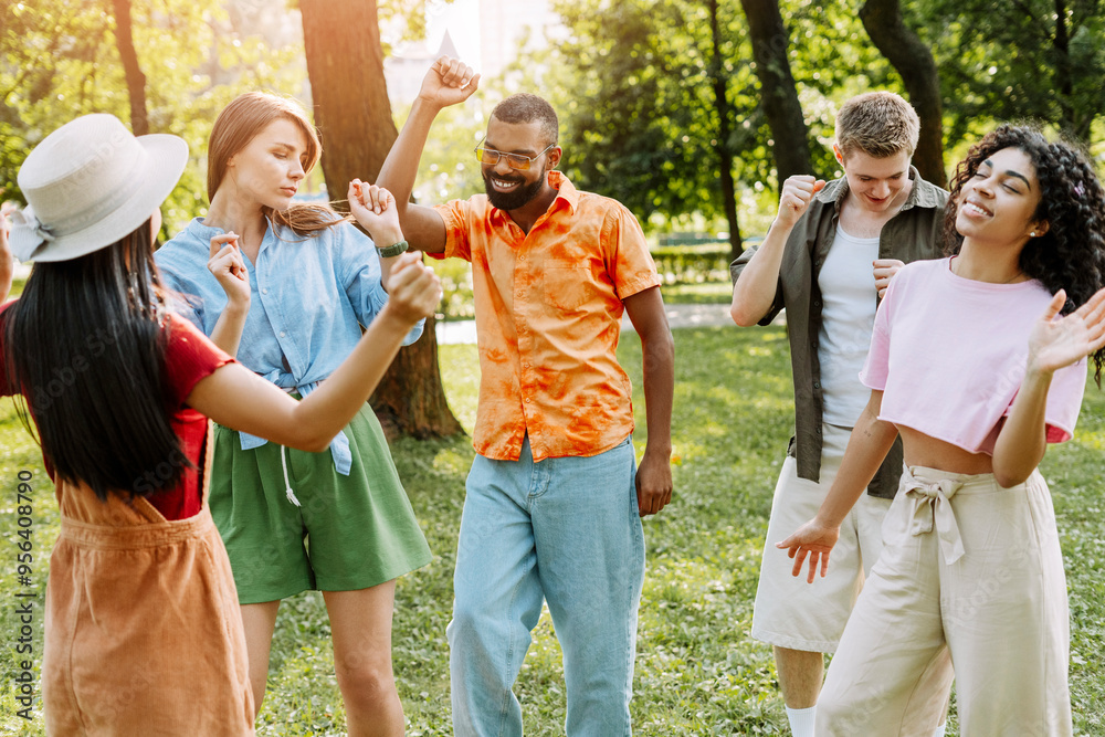 Diverse group of multinational friends dancing together in the park Diverse group of multinational friends dancing together in the park