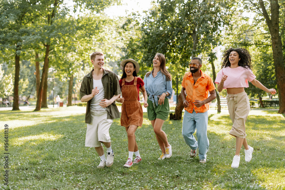Happy, smiling diverse, multinational friends running together in the park Happy, smiling diverse, multinational friends running together in the park