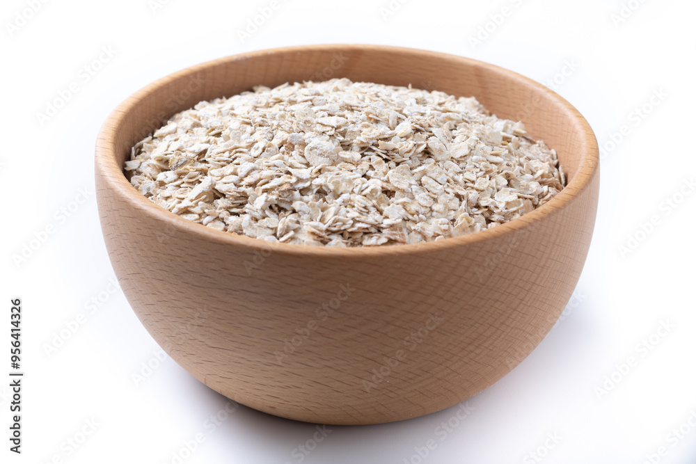 Rolled oats, healthy breakfast cereal oat flakes in bowl isolated on white background Rolled oats, healthy breakfast cereal oat flakes in bowl isolated on white background