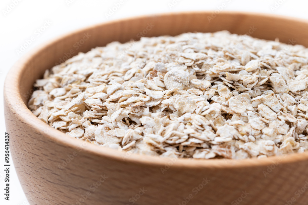 Rolled oats, healthy breakfast cereal oat flakes in bowl isolated on white background. Close up Rolled oats, healthy breakfast cereal oat flakes in bowl isolated on white background. Close up