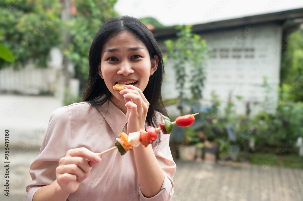 Fototapeta premium Asian woman enjoy eating barbeque