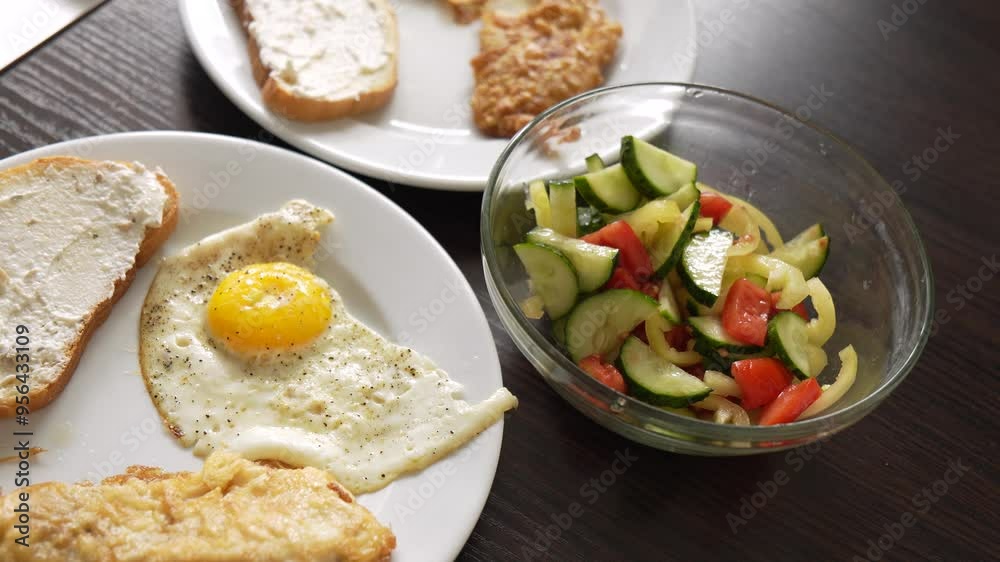 Breakfast fried eggs with salad and toast. Two servings Breakfast fried eggs with salad and toast. Two servings