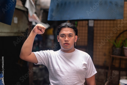 A young indignant Filipino man protesting over being evicted. A resident of a marginalized squatter area or slum community. photo