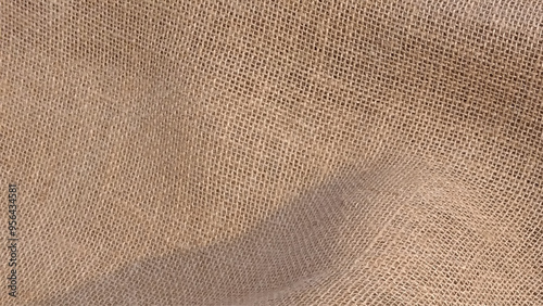 Detailed close-up of natural burlap fabric texture with woven pattern. Brown rough linen fabric texture close-up as background.