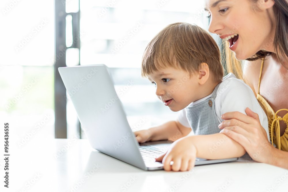 Mother and Son Enthusiastically Watching Something on a Laptop Together